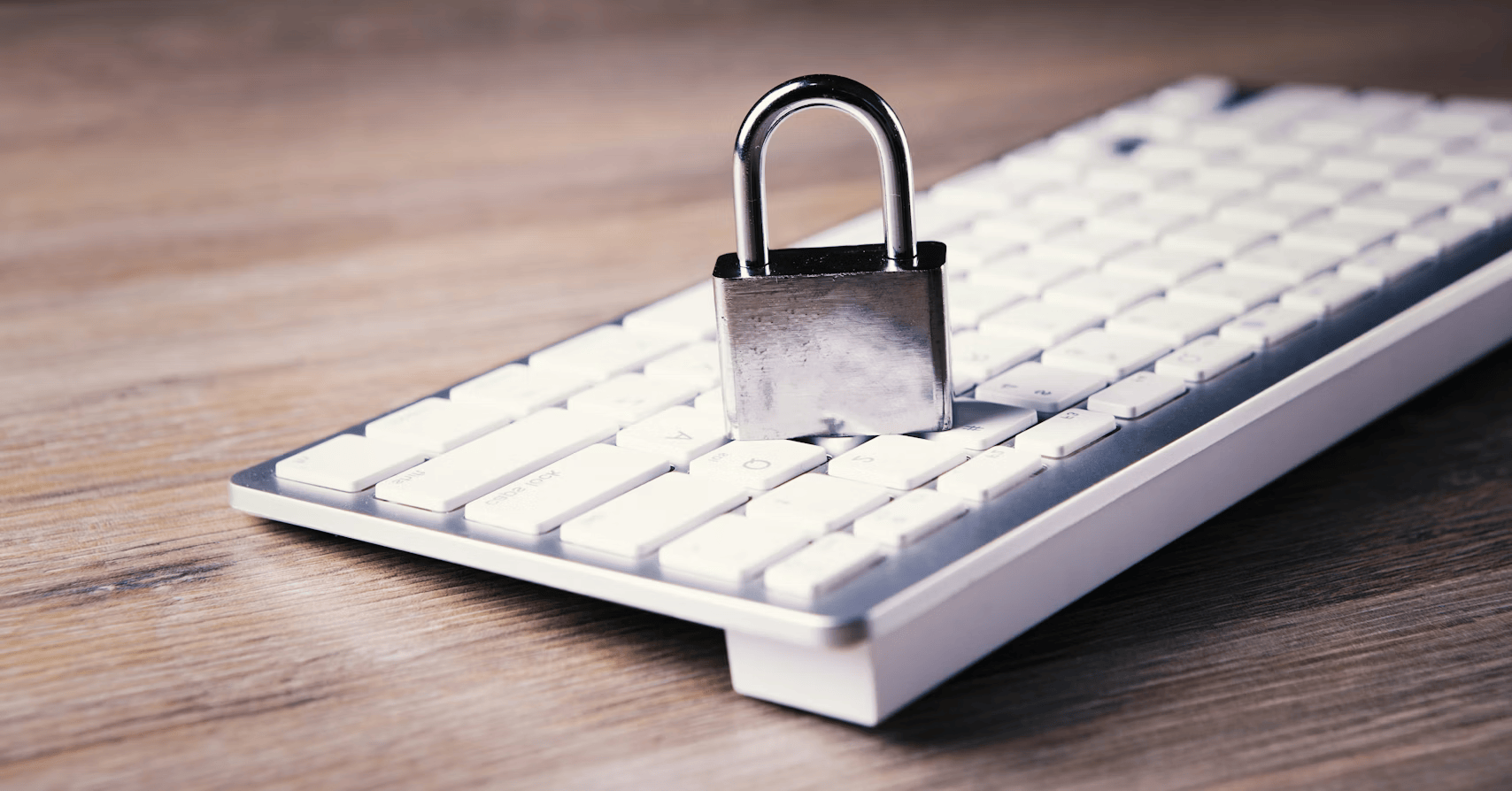 Padlock on computer keyboard representing cybersecurity